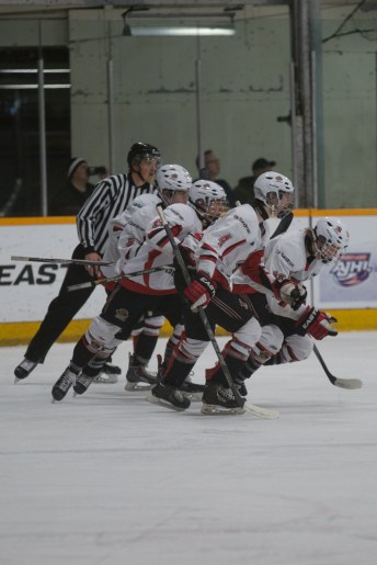 Cariboo Cougars celebrate their first goal in the quarter final of the Mac's AAA Midget tournament © J. Ashley Nixon