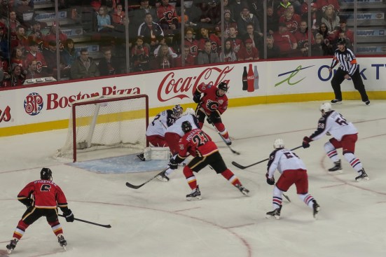 Jiri Hudler passes to Sean Monahan to score on the power play © J. Ashley Nixon
