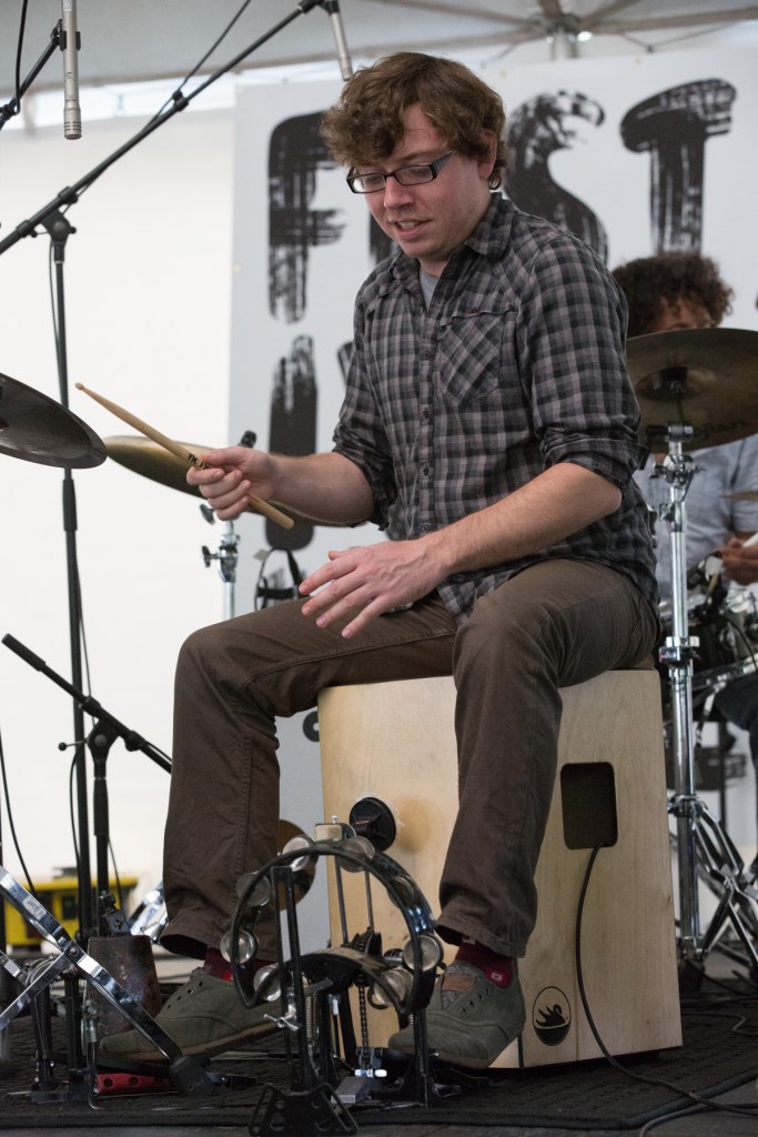 Jordan Ellis playing Cajon © J. Ashley Nixon