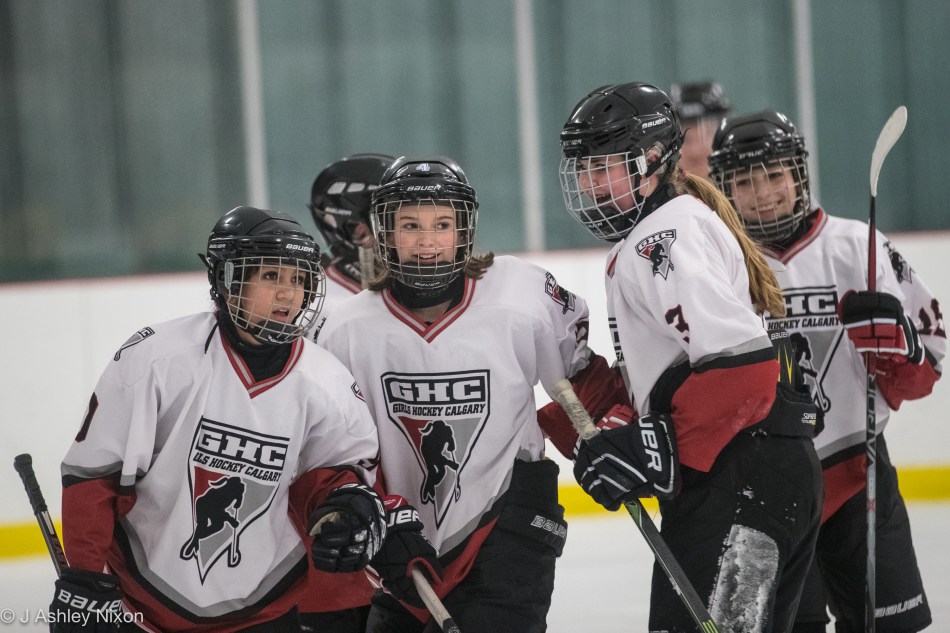 Calgary Girls Hockey Bantam 1 (White Hawks) celebrate a goal in a tournament at Canal Flats, BC, Canada. © J. Ashley Nixon