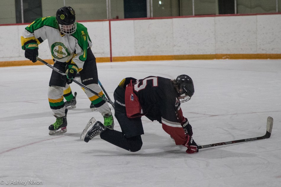 A tripping penalty presents the Calgary White Hawks Bantam Girls with a power play opportunity in their Calgary City hockey championship game against Okotoks Oilers in Black Diamond, Alberta, Canada. © J. Ashley Nixon