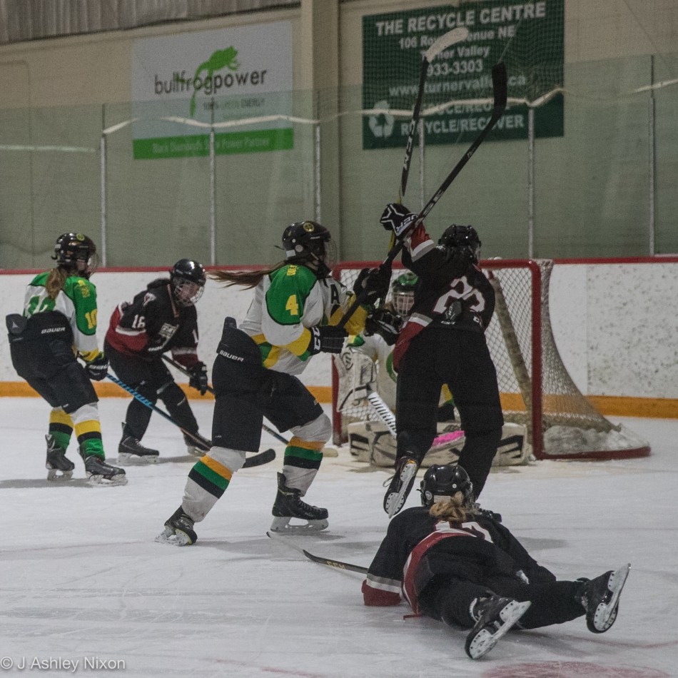 Carolyn Berze flies through the air to score the second of three goals in a minute for the Calgary Girls Hockey Bantam White Hawks against the Okotoks Oilers in the first round of the Calgary City hockey championships in Black Diamond, Alberta, Canada. © J. Ashley Nixon