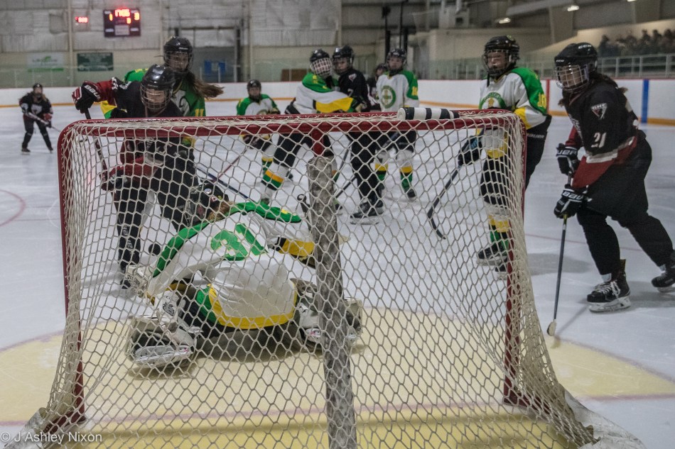 Action from the Calgary City hockey championship first round game between Calgary Girls White Hawks and the Okotoks Oilers in Black Diamond, Alberta, Canada. © J. Ashley Nixon
